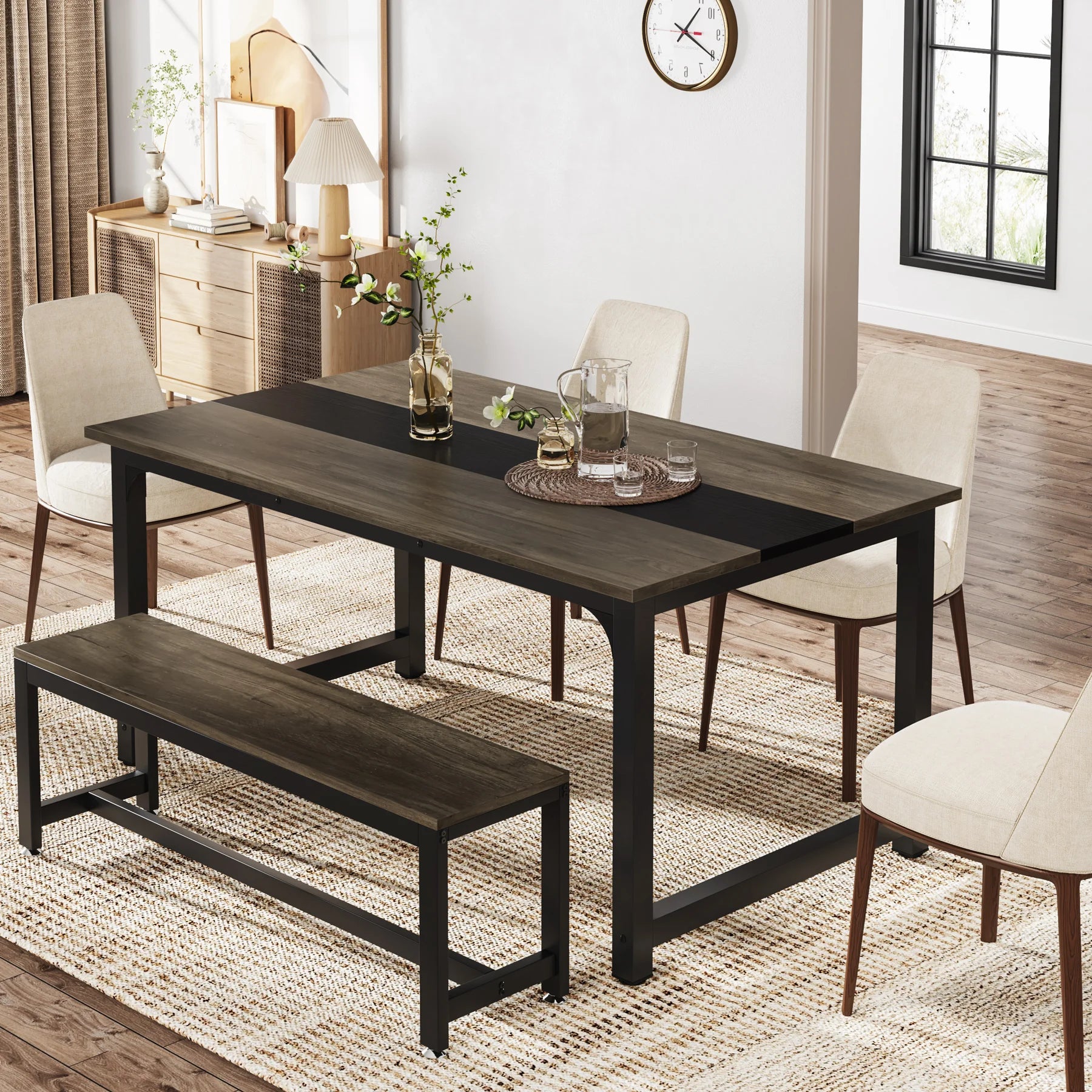 Dining room setup with a dark wooden table, chairs, and bench on a wooden floor.