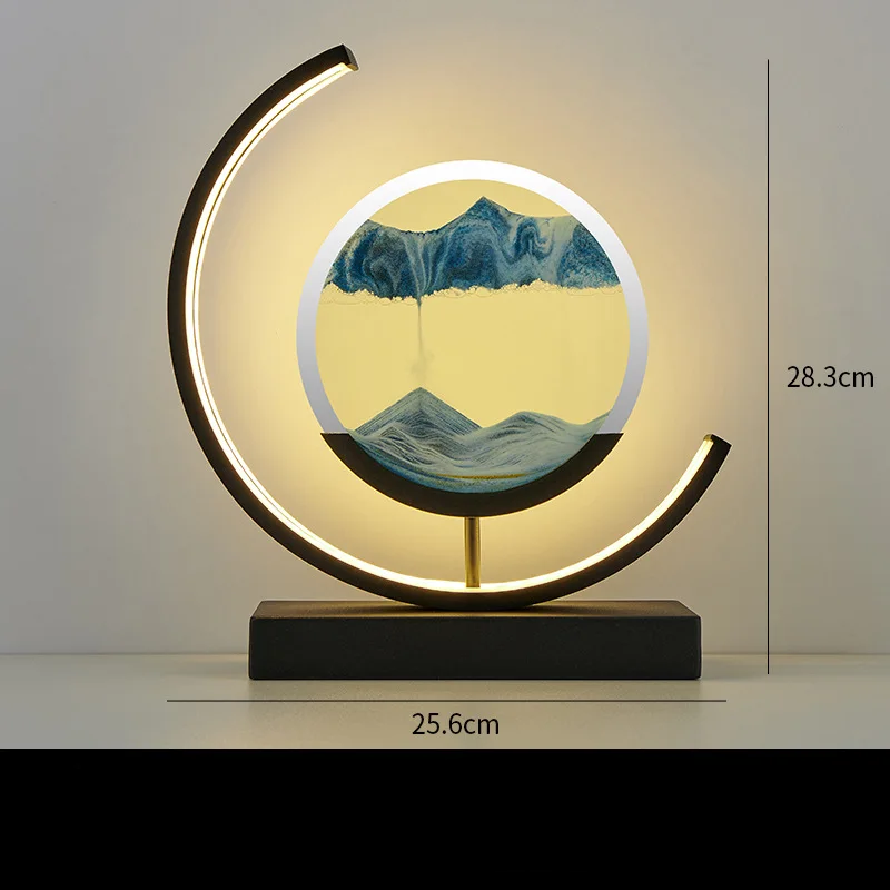 Desk lamp with geometric design, softly lit, showing sand slowly falling inside.