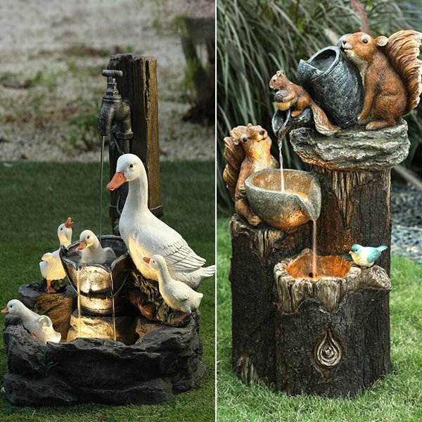 Two decorative garden fountains with animals on a grassy background