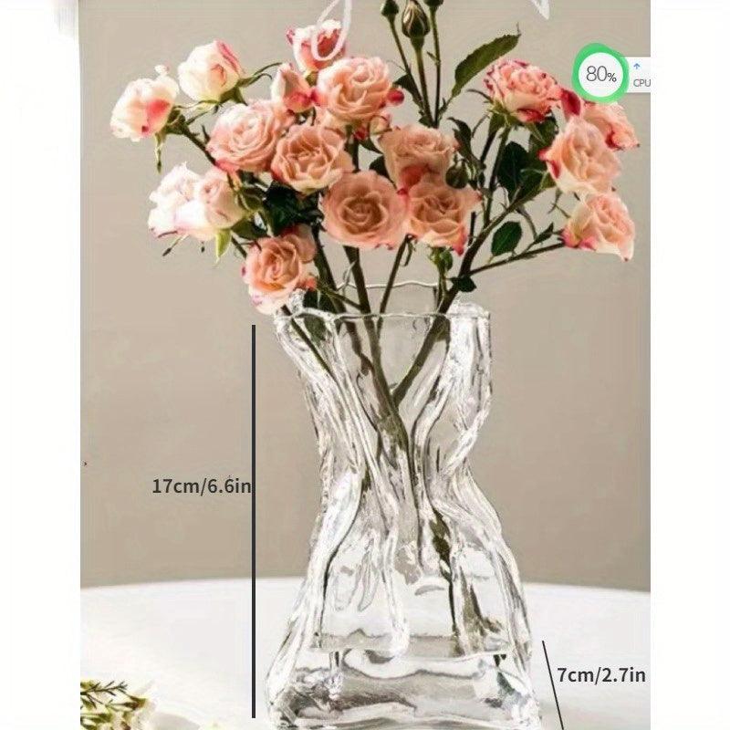 Cylindrical transparent glass vase for fresh or dried flowers.