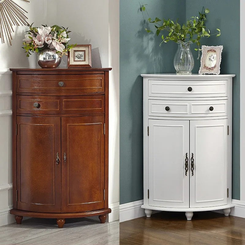 Two corner cabinets, one wooden and one white, against a wall with decorative items on top.