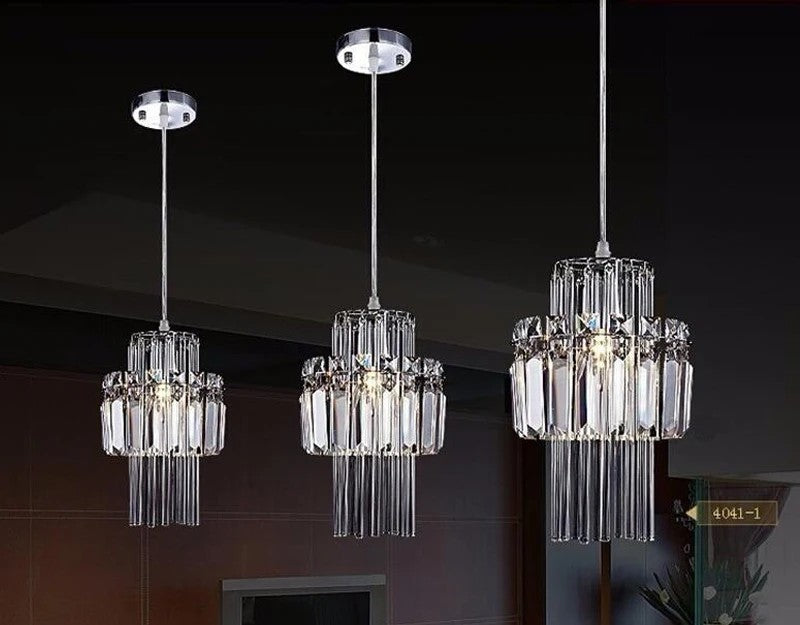Three crystal pendant lights hanging against a dark background