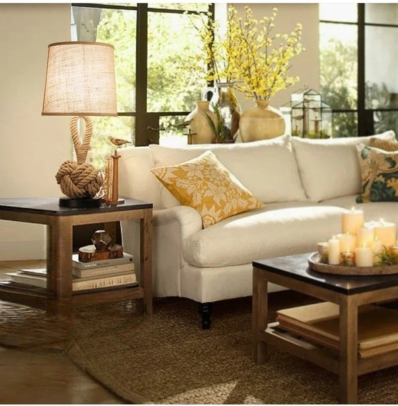 Cozy living room with a white sofa, wooden coffee table, and decorative items.
