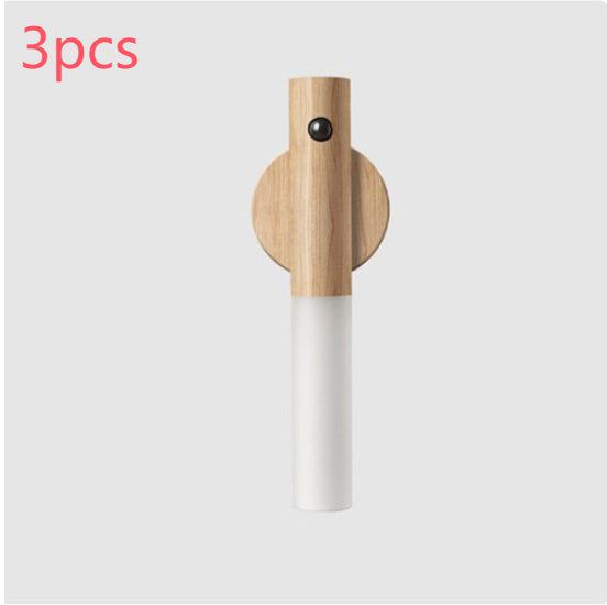 Wooden and white cylindrical product on a light gray background with &