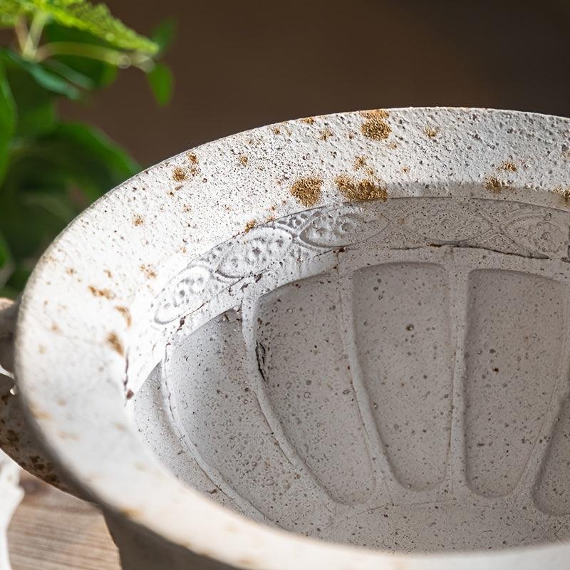 Durable metal vase with vintage floral engravings.