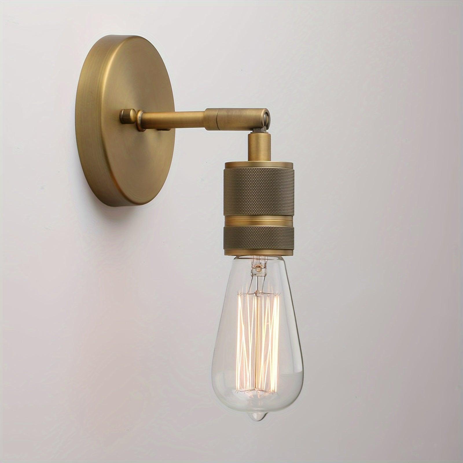 Vintage industrial wall sconce with an antique bronze finish for indoor lighting.