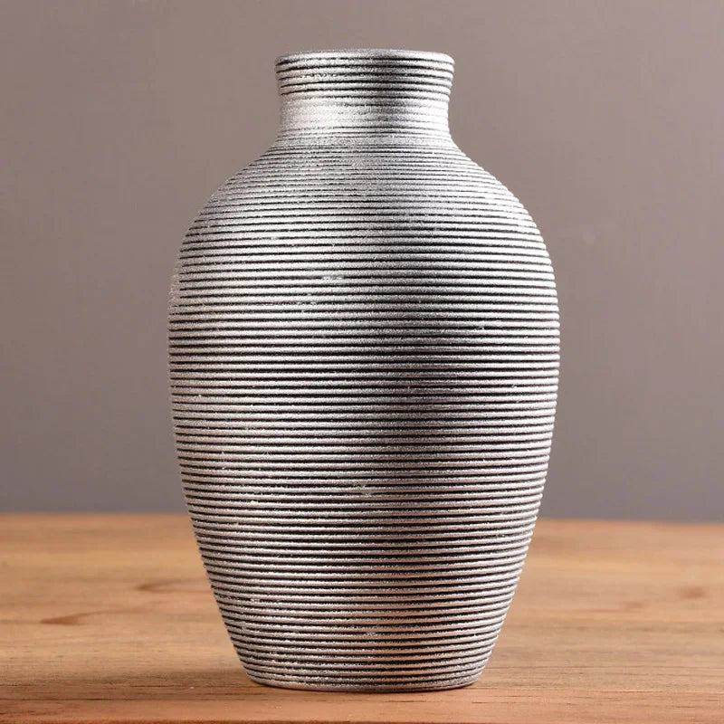 Textured vase on a wooden surface with a neutral background