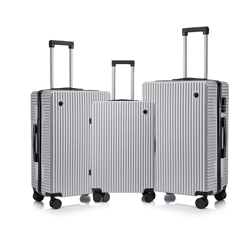 Set of three silver suitcases with black wheels on a white background