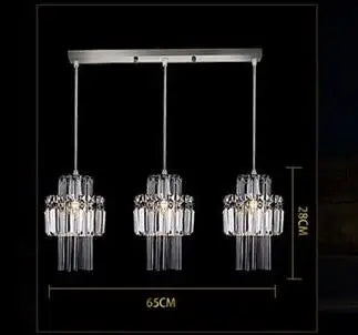Three-tiered pendant light with crystal design on a black background