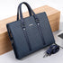 Blue patterned briefcase with a strap on a light wooden block