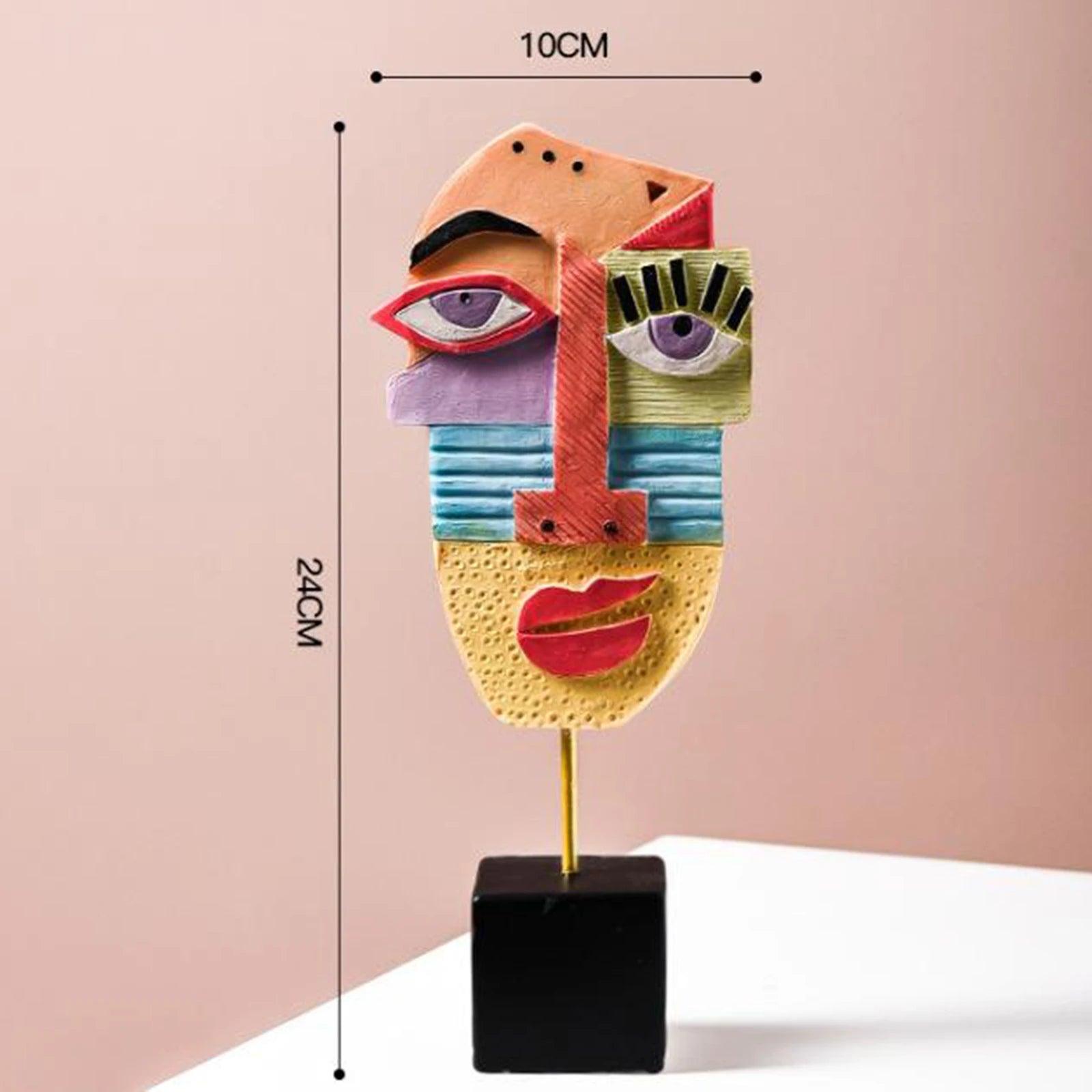 A colorful abstract resin figurine resembling a stylized face, displayed on a black stand with measurements indicating its height and width.