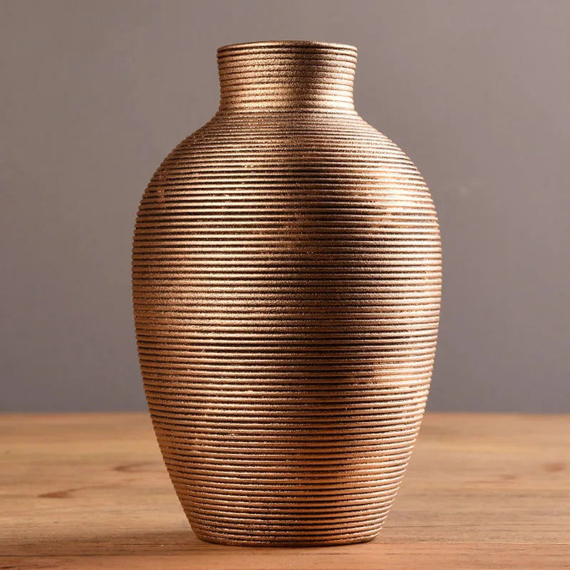 Textured vase on a wooden surface with a neutral background