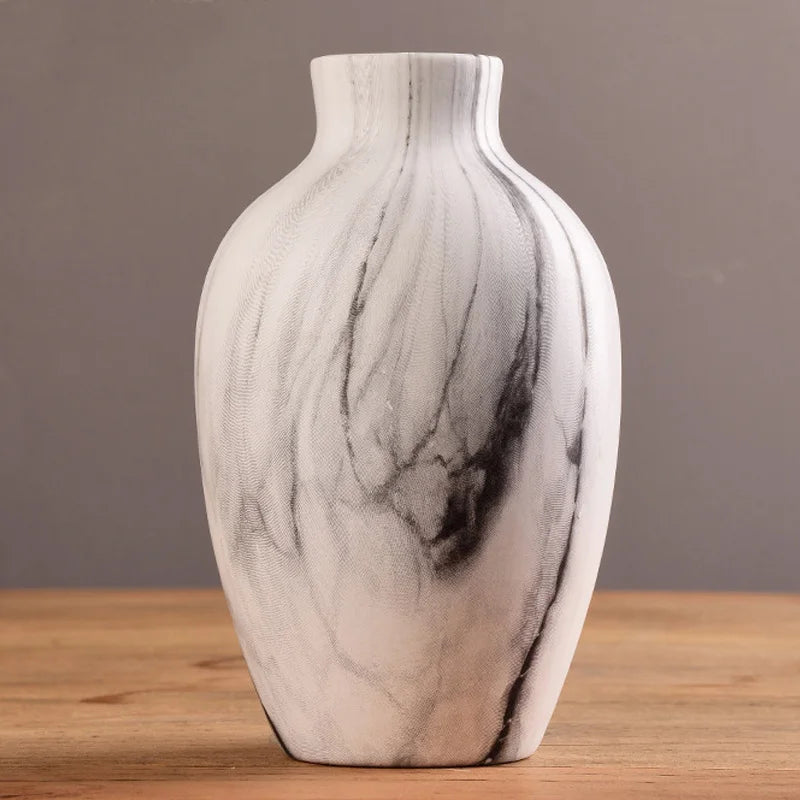 Marble-patterned vase on a wooden surface with a gray background