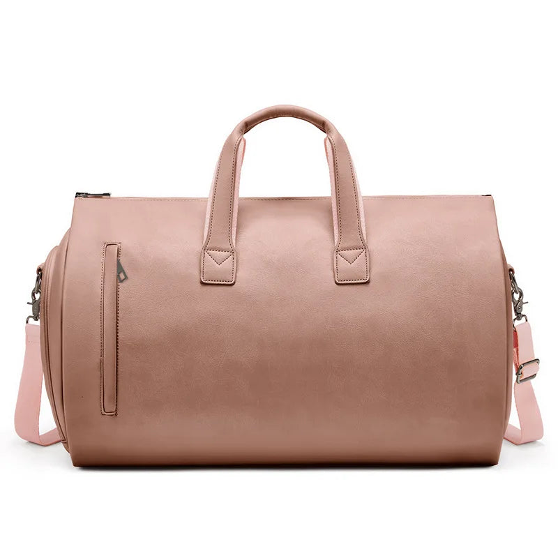Pink leather duffel bag with shoulder strap on a white background