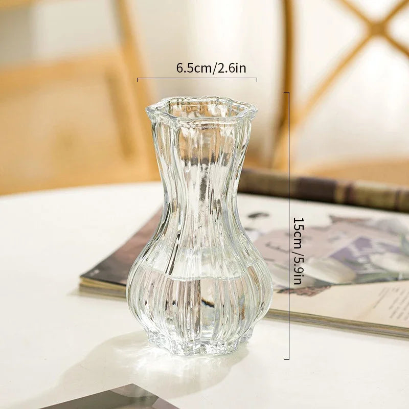 Clear glass vase on a surface with dimensions indicated