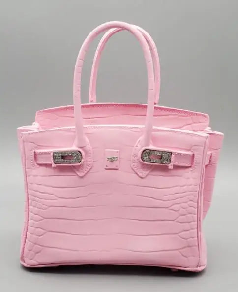 Pink handbag with silver hardware on a grey background Decorative resin bag-shaped vase