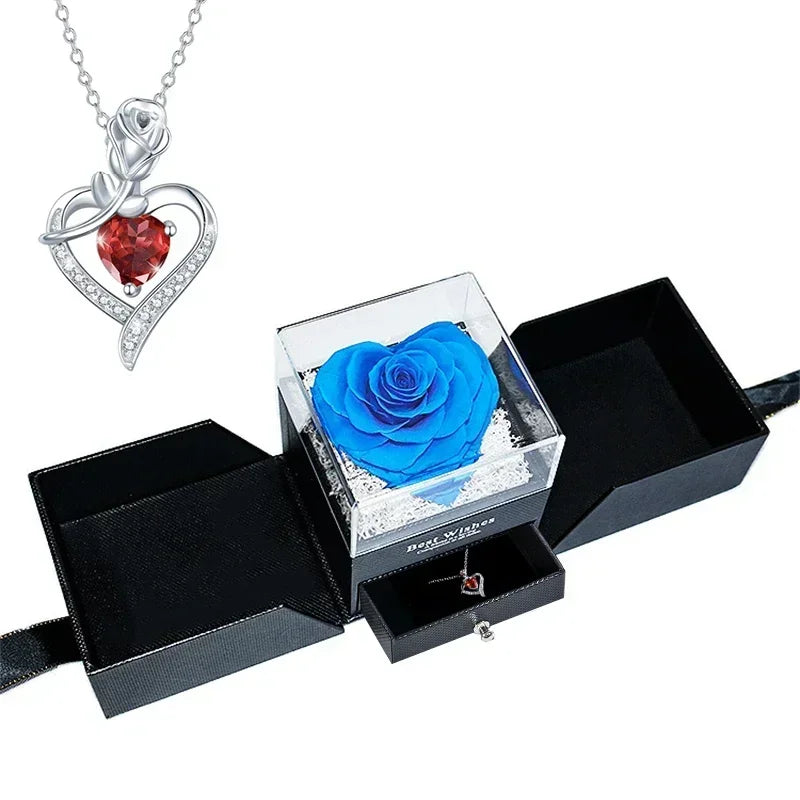 Heart-shaped jewelry box with a preserved rose and necklace inside.