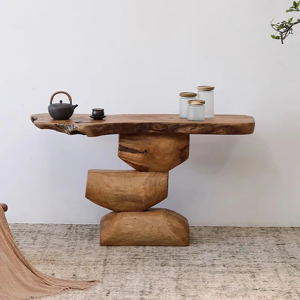 Wooden console table with rustic design against a white wall