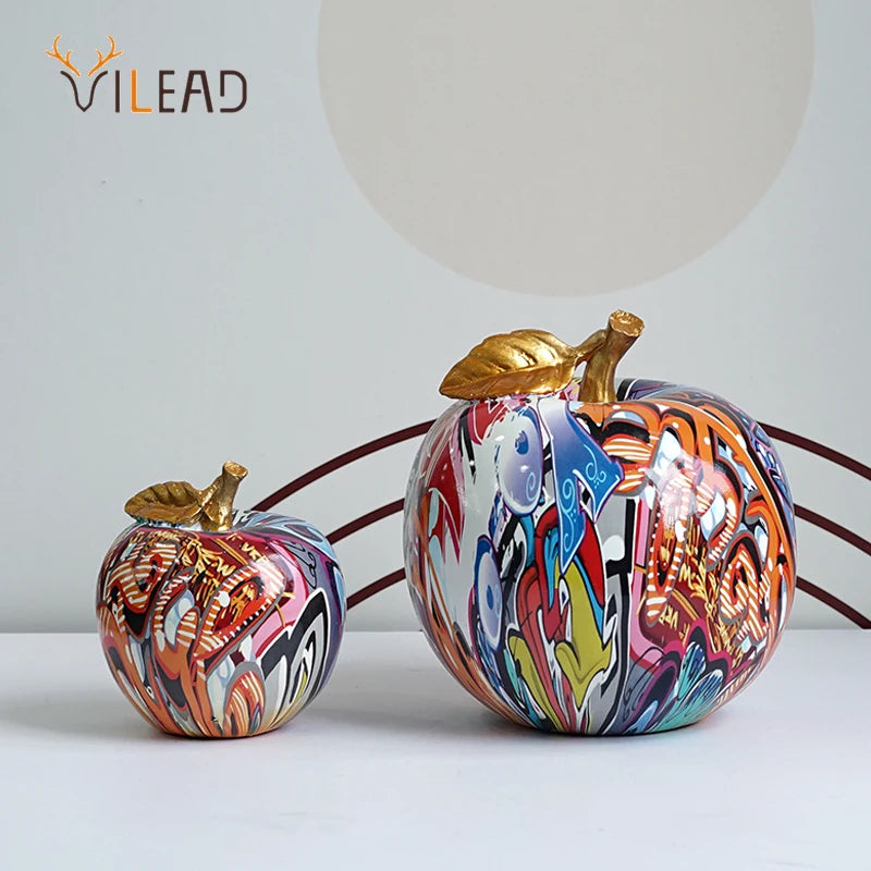 "Close-up of vibrant graffiti art on a resin apple decor piece"