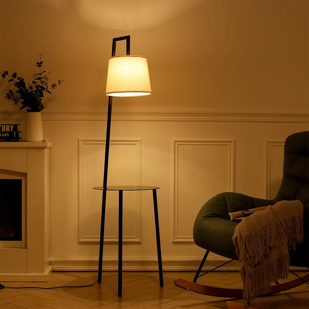 Floor lamp in a cozy living room with a chair and decorative items.