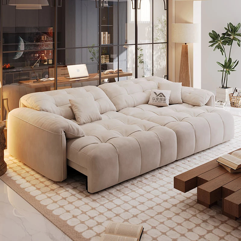 Beige sectional sofa in a modern living room with a desk and decor.