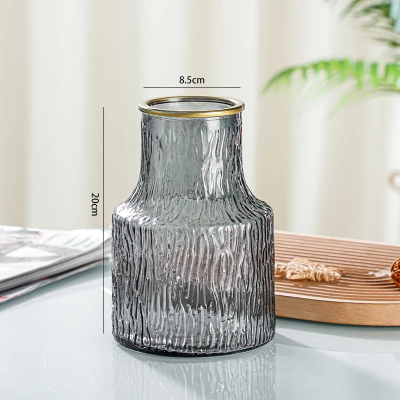 Clear textured vase with gold rim on a light surface, measurement details shown.