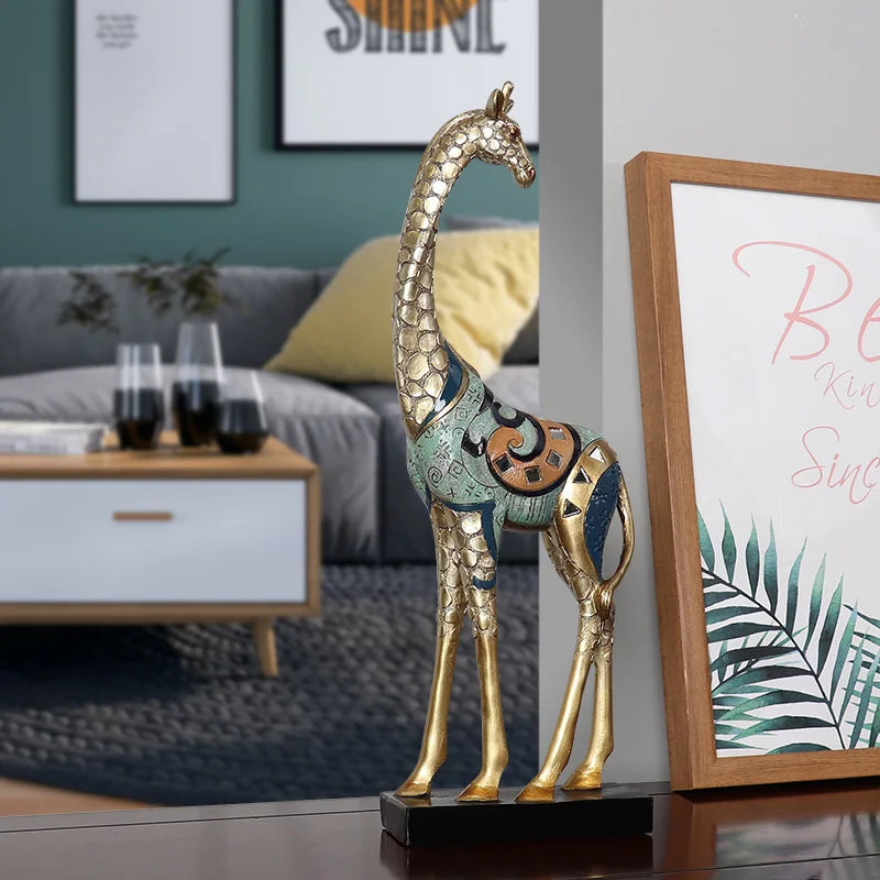 Decorative giraffe statue in a living room setting with a couch and framed pictures.