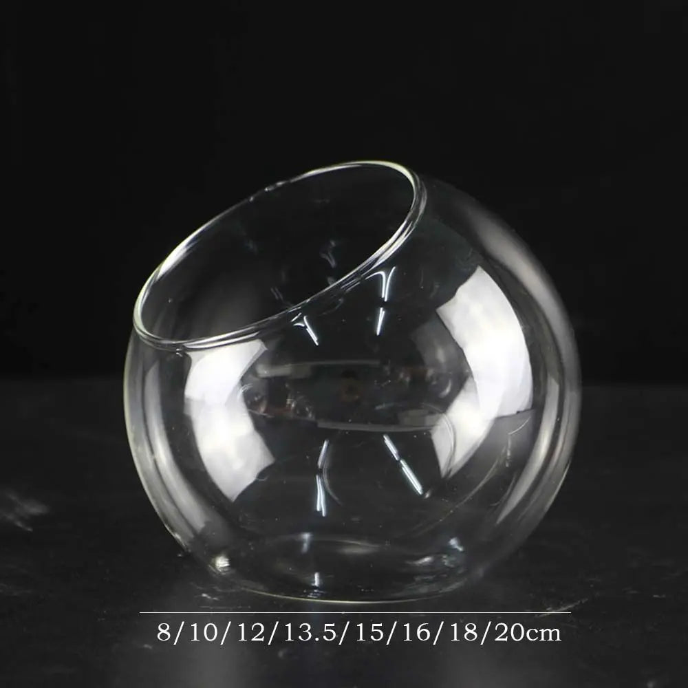 Clear glass fishbowl with size measurement markings on a dark background