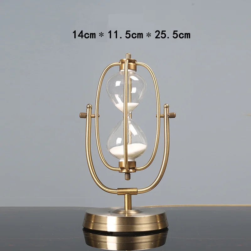 Gold hourglass-shaped table lamp on a gray surface with dimensions displayed.