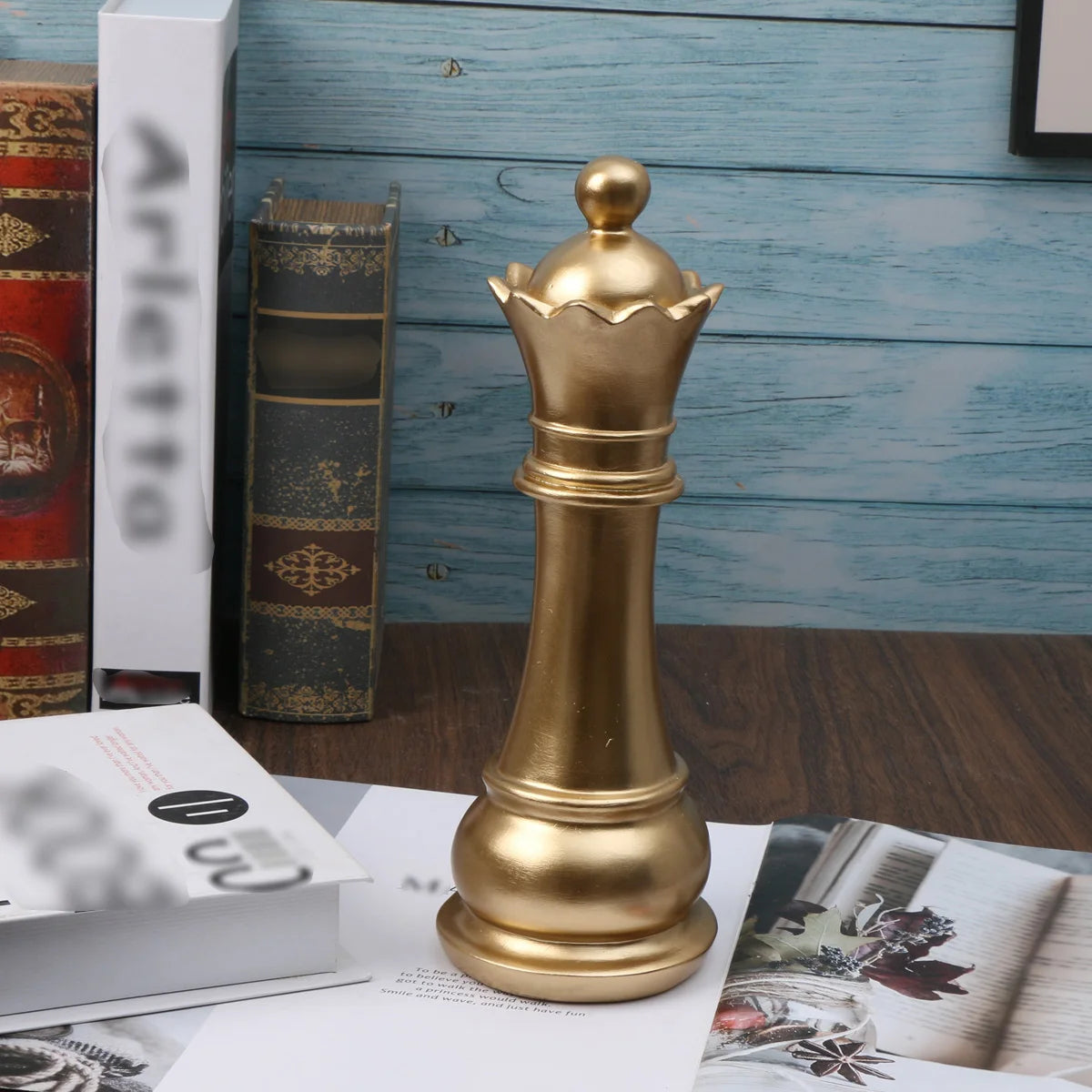Gold chess piece on a magazine with books in the background