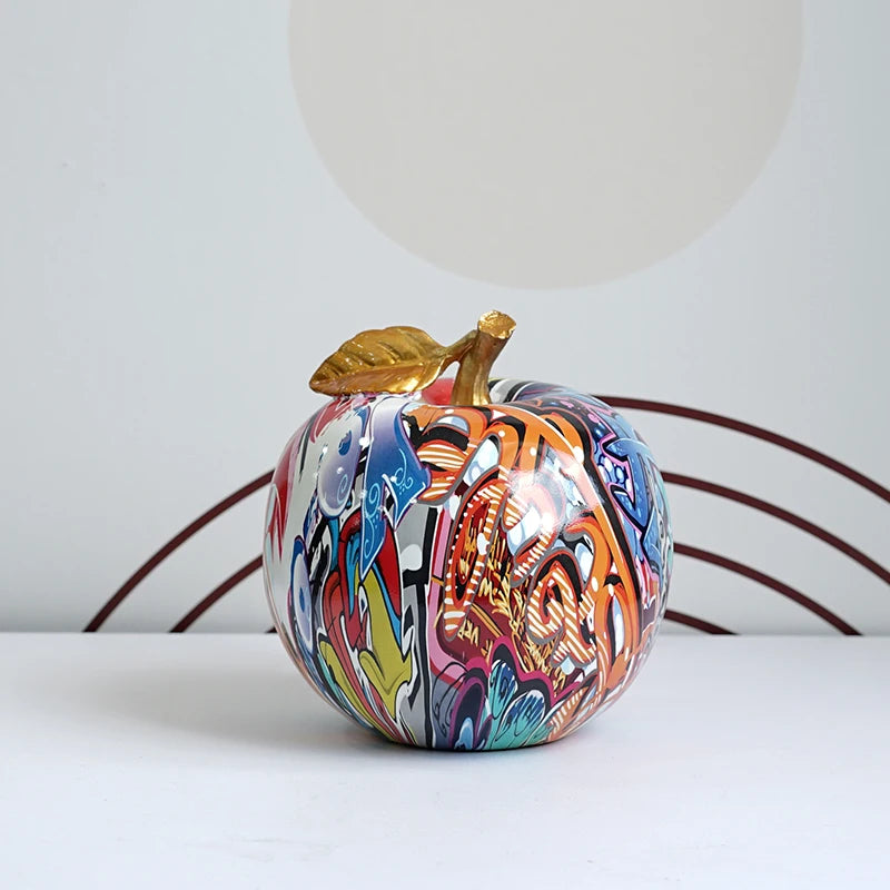 "Artistic resin apple figurine on an office desk setup"