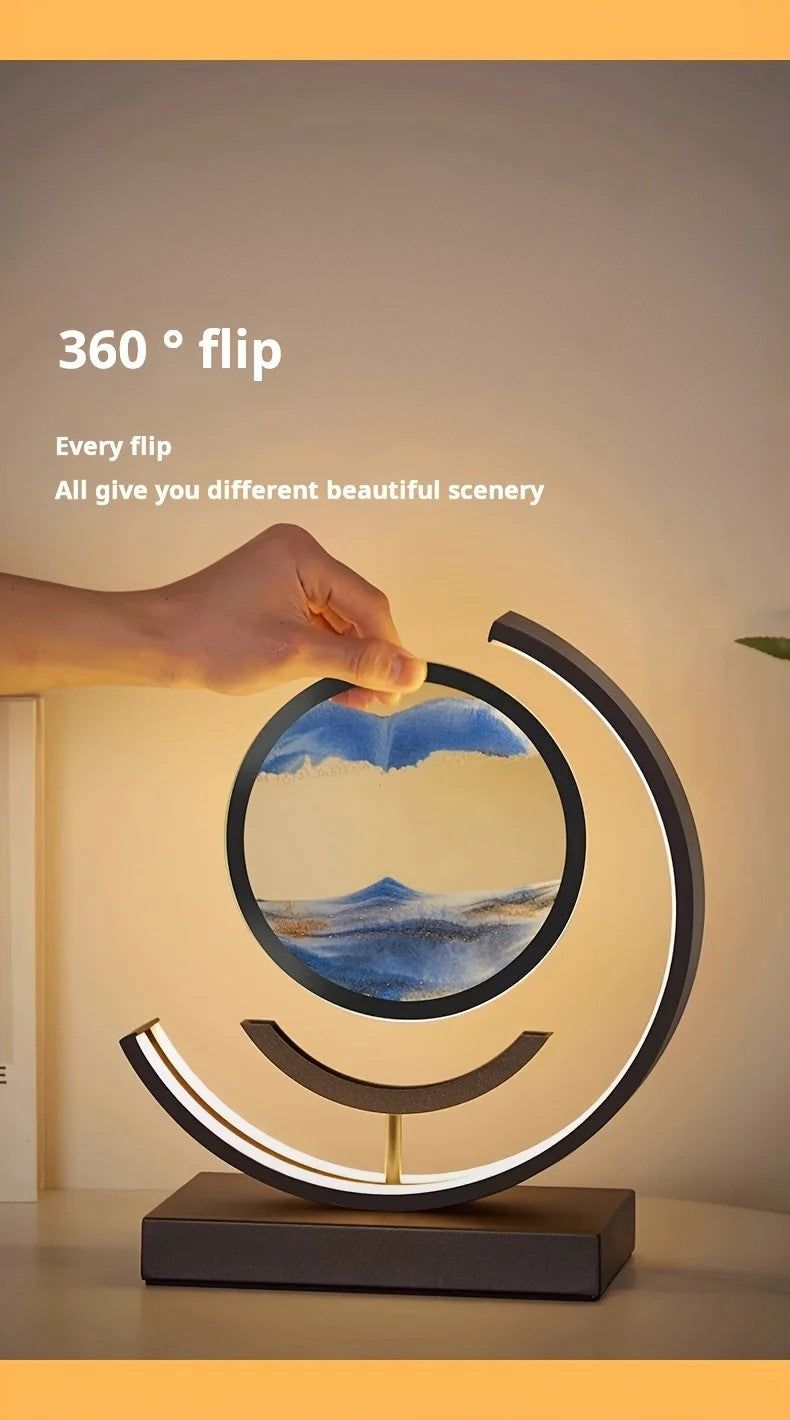 Circular table lamp with scenic design on a stand, held by a hand.