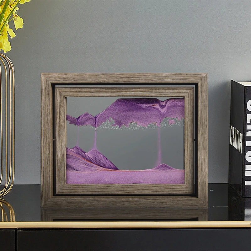 Framed abstract artwork with purple and pink hues on a gray surface.