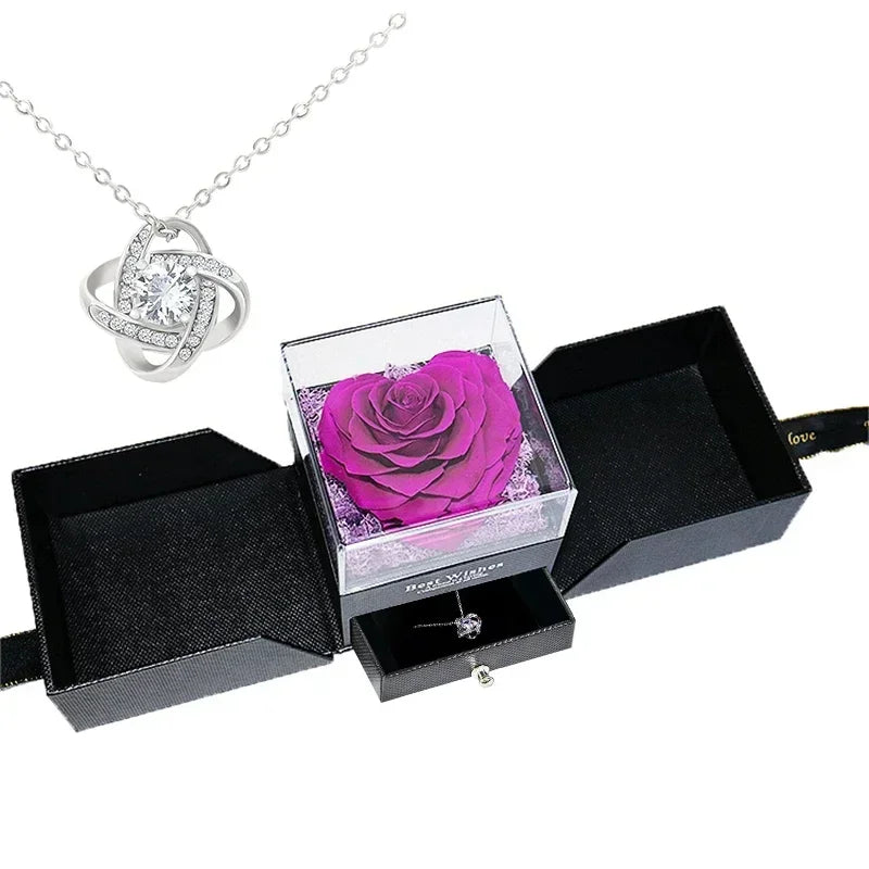 Heart-shaped jewelry box with a preserved rose and necklace inside.