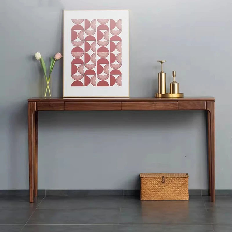 Wooden console table with decorative items against a gray wall
