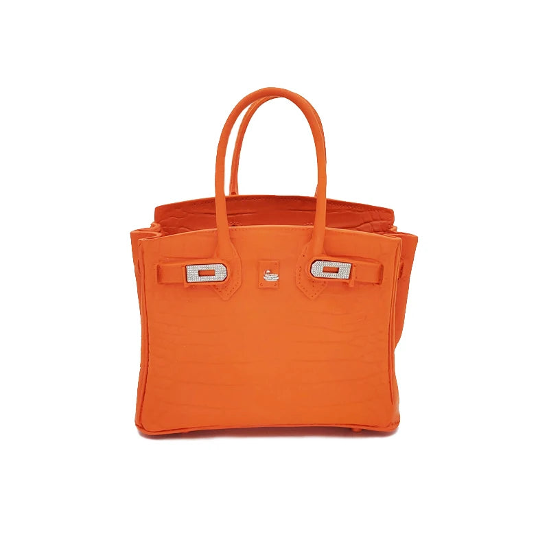 Orange handbag with silver hardware on a white background Home décor resin handbag vase