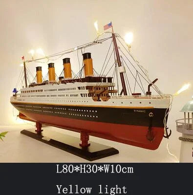 The sailboat model displayed on a shelf or mantelpiece in a home setting.