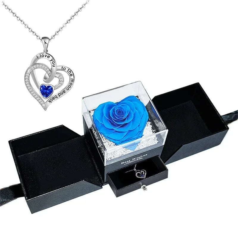 Heart-shaped jewelry box with a preserved rose and necklace inside.