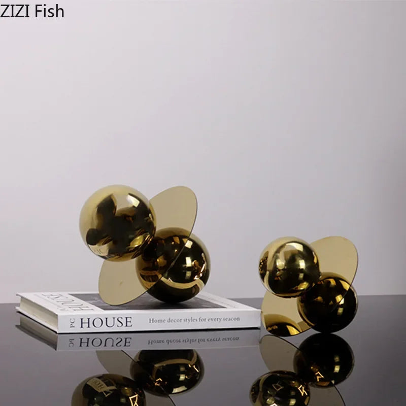 Gold decorative propellers on a reflective surface with a book titled &