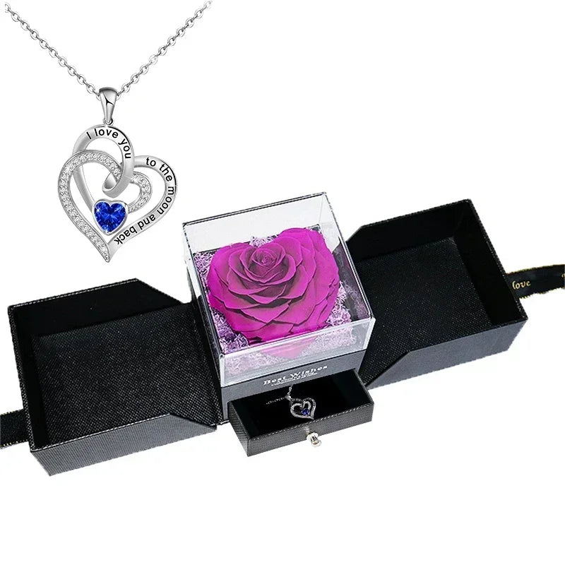 Heart-shaped jewelry box with a preserved rose and necklace inside.