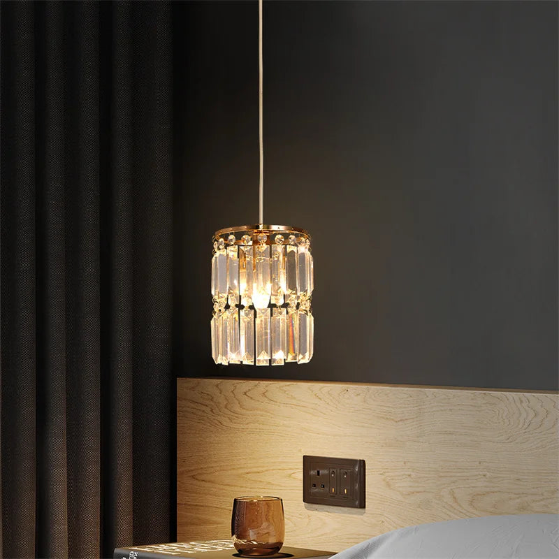 Decorative pendant light hanging above a bed in a bedroom setting.