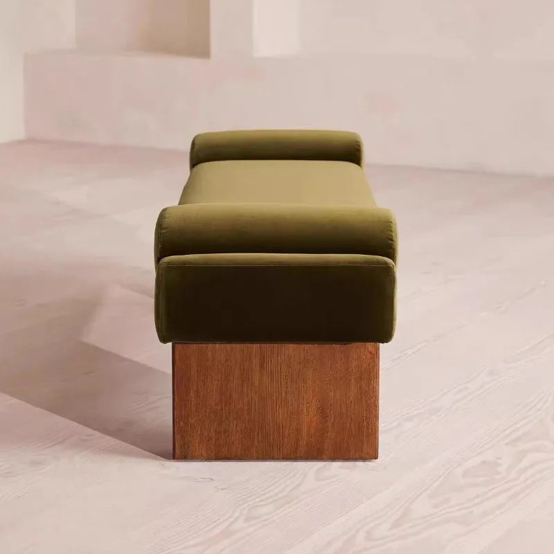 Green upholstered bench with wooden base on a light background