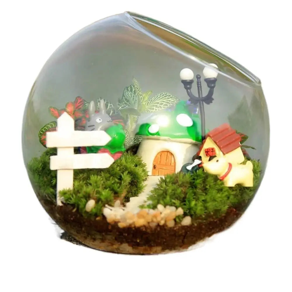 Miniature garden scene with a mushroom house, dog, and lamp post inside a transparent sphere.