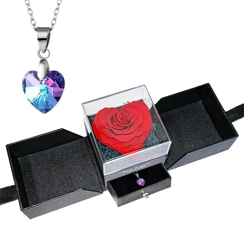 Heart-shaped jewelry box with a preserved rose and necklace inside.