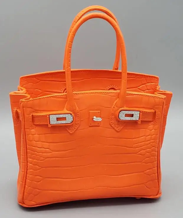 Orange handbag with a textured pattern on a grey background Contemporary room ornament vase