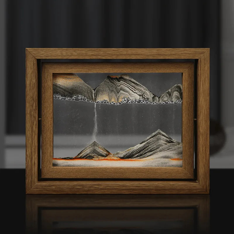 Framed artwork of a mountain landscape with a waterfall on a dark background