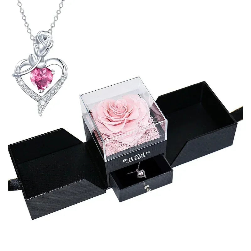 Heart-shaped jewelry box with a preserved rose and necklace inside.