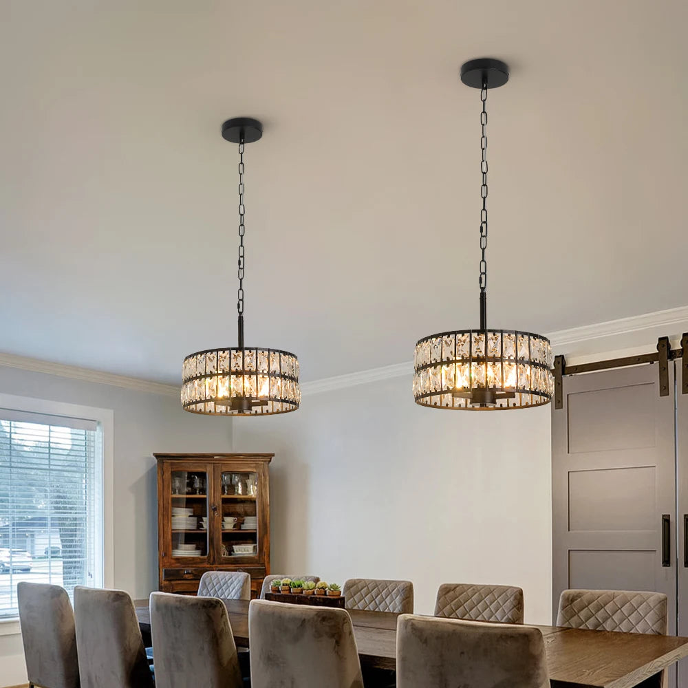 Dining room with two hanging chandeliers, a table, and chairs.