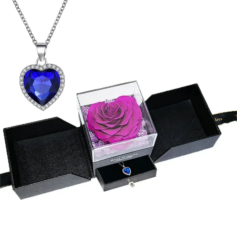 Heart-shaped jewelry box with a preserved rose and necklace inside.