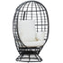 Egg-shaped wicker chair with white cushions on a white background